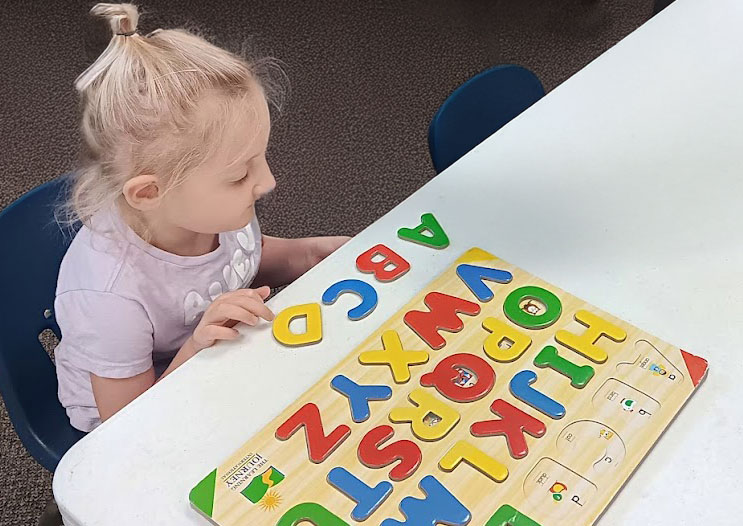 Child playing with letters